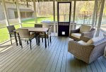 Comfy, furnished screen porch with views of the pool area and acreage 